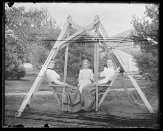 Mrs. Walker, Annie Persis Woodward, and Marion Woodward in lawn swing