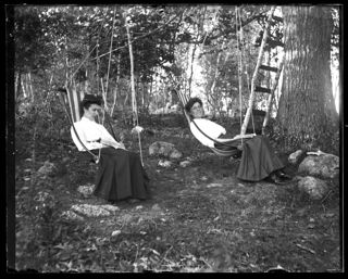 "Buxom" and "Artful" in swing chairs at Patten Pond, September 1905