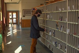 Student picking up their mail on campus