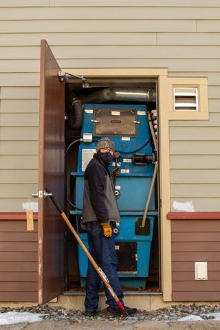Student Odin Gage maintains the composting toilets