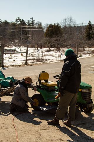Jake Totten shows student how to fill tire