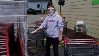 Hannaford employee sanitizing shopping carts