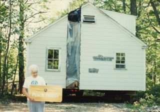 Ann Peach with the Peach House sign