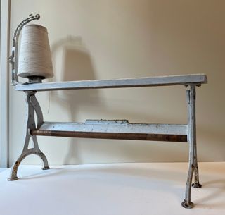Cast iron wrapping paper stand with twine attachment