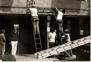 Hanging the new sign at the Great Harbor Collection