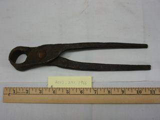 Large metal pliers with broad head