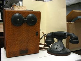 Antique telephone with wooden box and hand crank