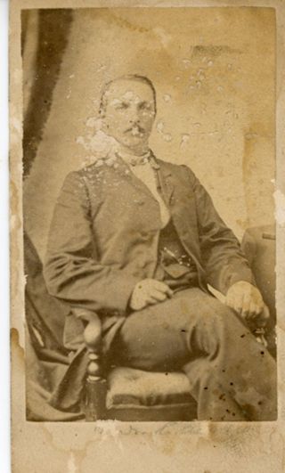 Man seated in a chair wearing suit