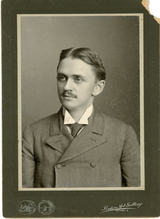 Portrait of man in fine striped suit with black tie
