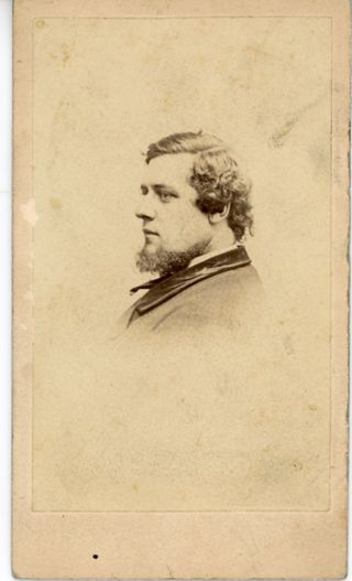 Man in profile with dark curly hair