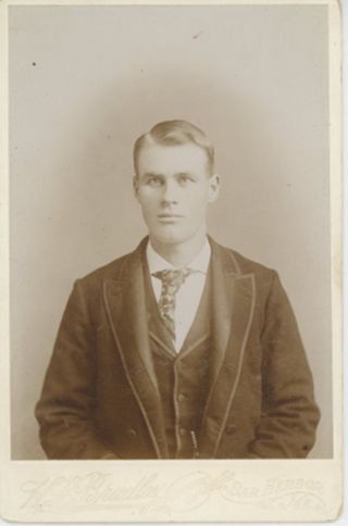 Portrait of young man in dark suit