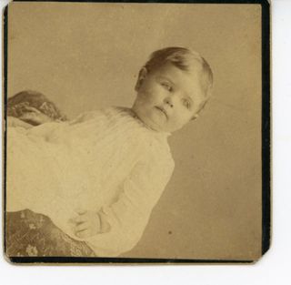 Baby on patterned cushion
