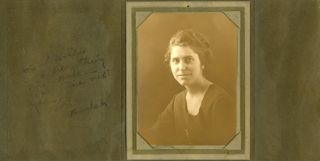Woman in dark square necked dress