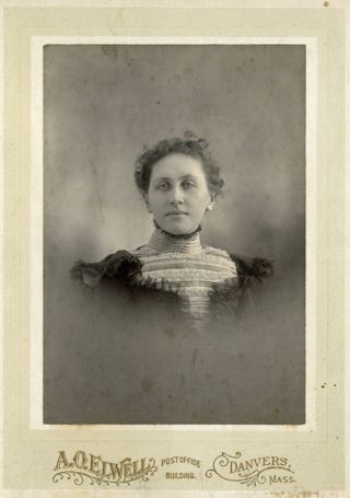 Portrait of woman in dark dress with ruffly bodice