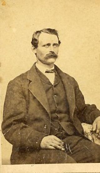 Man with dark hair and thick mustache