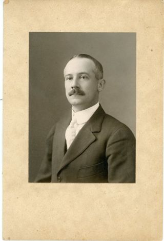 Man in dark suit white shirt