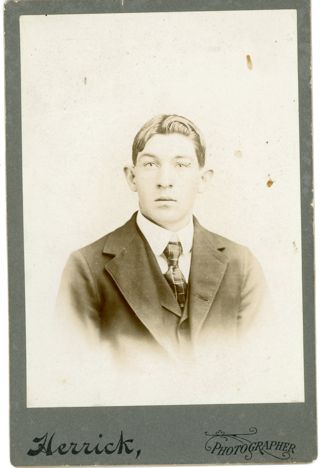 Man wearing dark suit and striped tie