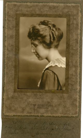 Woman in profile wearing dark dress with lace collar