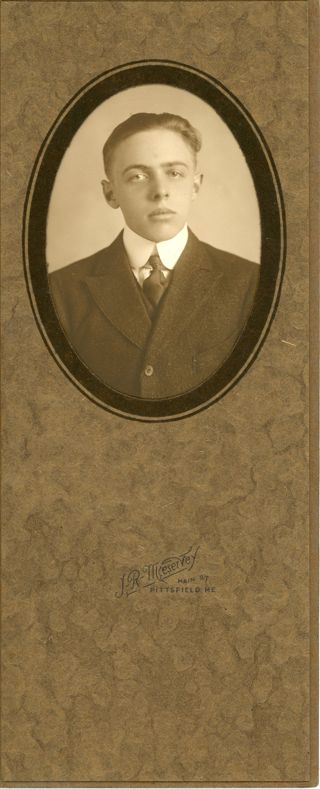 Man in dark suit in oval frame