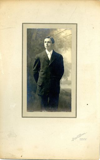 Man with hands clasped behind back