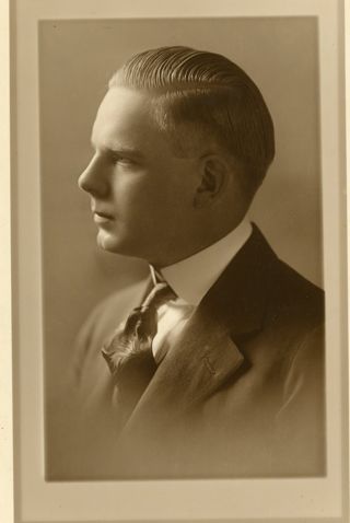 Man with blond hair wearing dark suit
