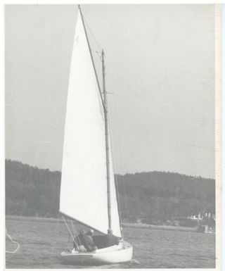 Three men aboard A class boat, headed to shore