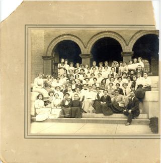 Group of women sitting in front of stone arches