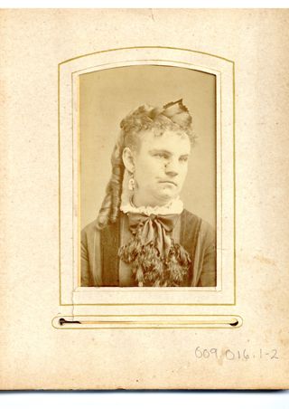 Unknown young woman with tasseled bow at neck