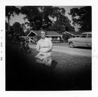 Woman Sitting on Lawn