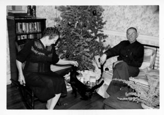 Couple with Cat and Christmas Tree