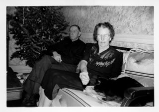 Couple with Cat and Christmas Tree