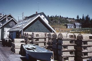 Wooden Traps Next to Blue Boat