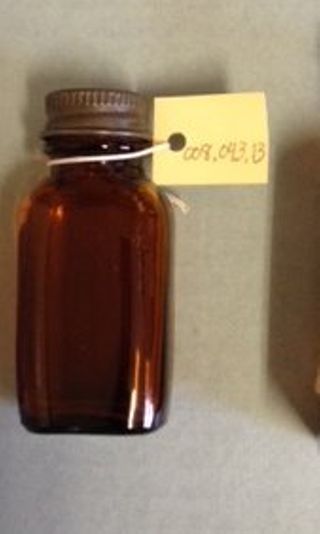 Small Brown Bottle with a Metal Lid
