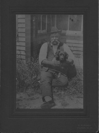 Trask, Lorenzo S., and his dog, sitting outside
