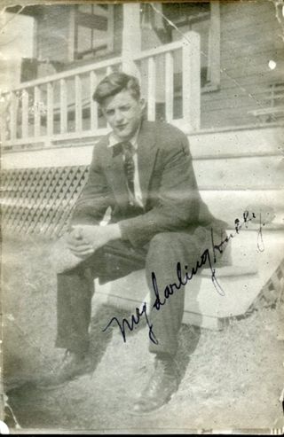 Woodbury Latty, young man, sitting on steps of house. Photo is inscribed: "My Darling Hubby".