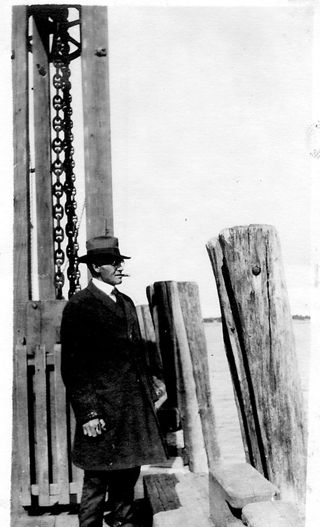 Loren Rumill, formally dressed, with cigar