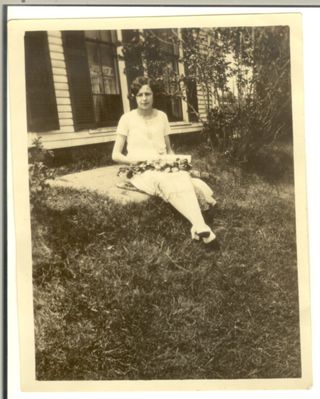 woman sitting at doorstep, believed to be Marie Rumill Allen Melanson
