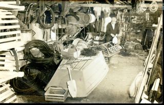 Old b&W postcard of Harvey Moore, working at Thurston's wharf