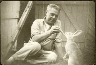 Albert Gott feeding a rabbit