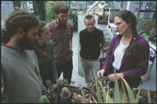 Suzanne Morse with class in greenhouse