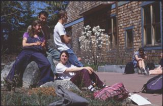 Unknown people sitting on Red Bricks